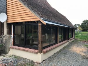 Reprise de la couverture, isolsation et fermeture de la veranda en menuiserie aluminium sur structure chêne.