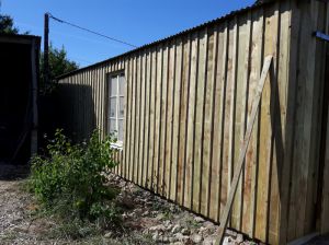 Habillage d'une ancienne maillère avec bardage à recouvrement, porte bois coulissante sur rails à SAINT AGIL (41).